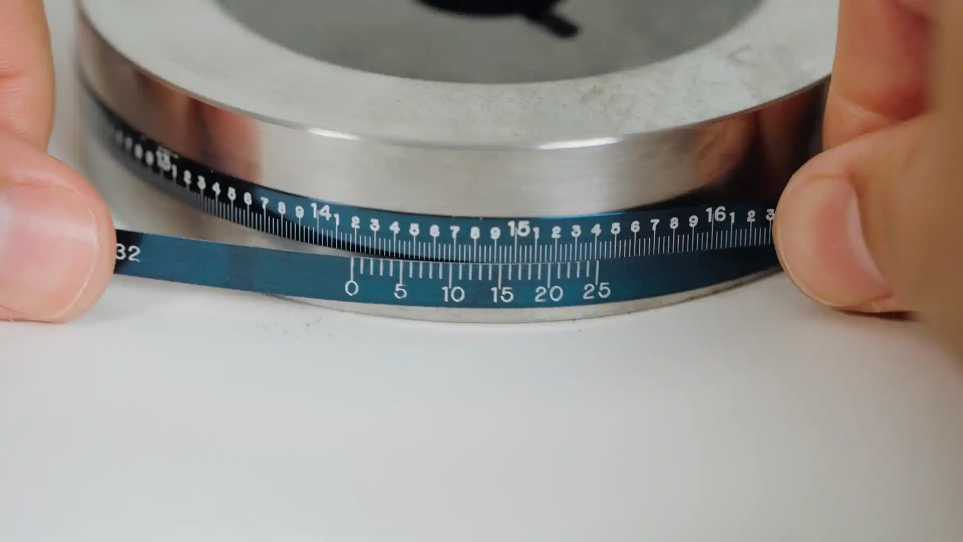 Blue Pi Tape outside circumference tape wrapped on a steel ring gage with the vernier scale visible